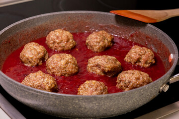 turkey meatballs cooking in cranberry sauce traditional thanksgiving