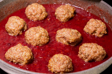 turkey meatballs cooking in cranberry sauce traditional thanksgiving