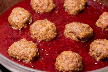 turkey meatballs cooking in cranberry sauce traditional thanksgiving