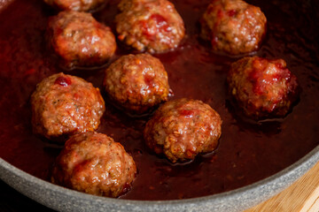 turkey meatballs with cranberry sauce in pan