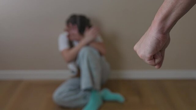 Emotion fills silence of girl hiding. Corner becomes symbol of trauma. Pain seen in child stillness. Girl avoids violence reaction. Trauma held in body language. Corner, trauma, and pain repeated