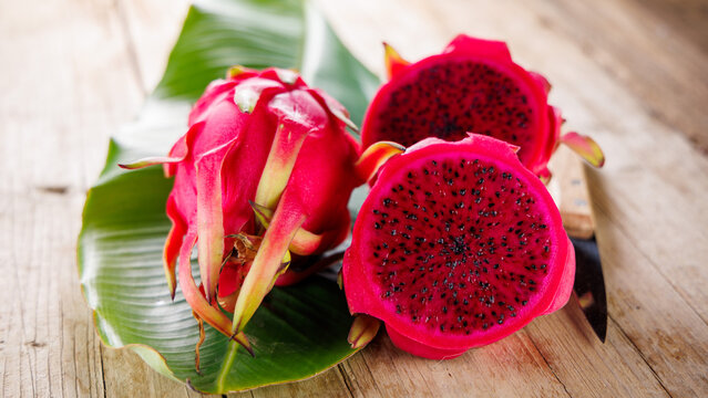 juicy dragon fruit or pitaya on green leaf