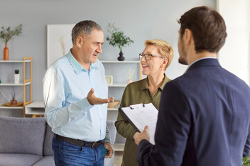 Discussing documents, real estate agent, broker represents senior sellers, buyers new contract,...