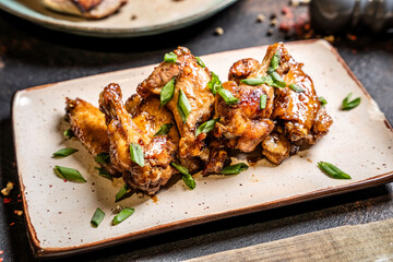 Glazed chicken wings with scallions