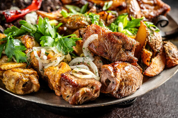 Grilled meat platter with herbs and onions