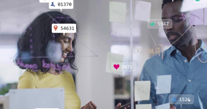 Marketing pair examining notes behind glass, woman tapping phone causing metrics overlay for review