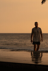 Man enjoying sunset tropical vacation lifestyle