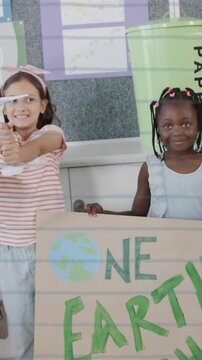 Children holding recycling signs and bags over environmental awareness animation