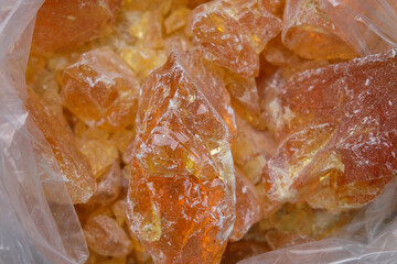 Close up of a piece of natural amber in a plastic bag.