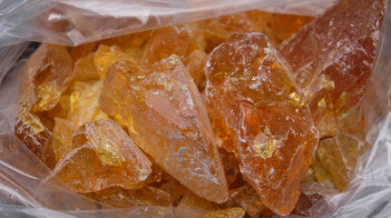 Close up of a piece of natural amber in a plastic bag.