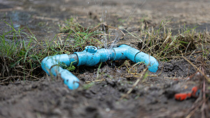 PVC water line of house plumbing system is leaking at the coupling connection. Building equipment object photo, close-up with selective focus.