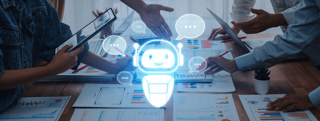 Teams collaborate in a modern office, utilizing a digital assistant to enhance productivity. Bright workspace features charts, laptops, and brainstorming sessions. Trope