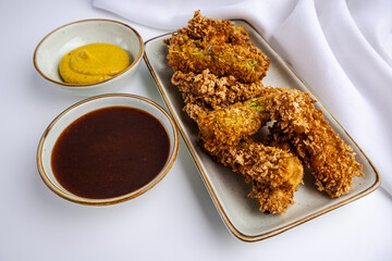 Zucchini fried in deep fryer. White background.