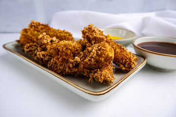 Zucchini fried in deep fryer. White background.