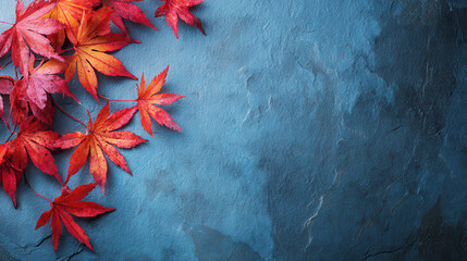 Vibrant red maple leaves on a textured blue background