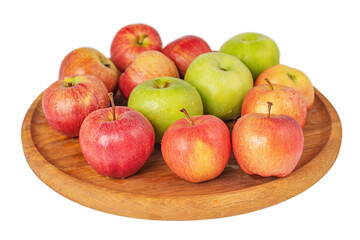 Red and green apples on a round wooden tray