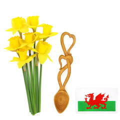 Welsh heart shape love spoon token of love, red dragon flag and daffodil flowers, national emblems for St Davids Day on white background.
