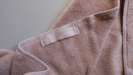 closeup, blank towel tag in brown color.