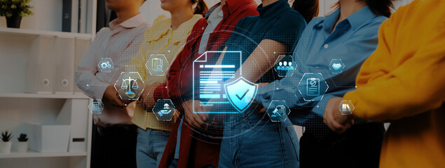 Group of diverse professionals standing together in an office environment, symbolizing teamwork and collaboration, with digital icons representing security and innovation. Trope