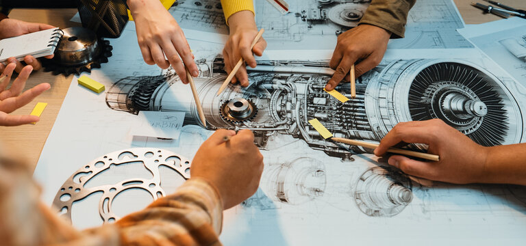 A dynamic scene showcasing diverse hands collaborating on a detailed engineering blueprint of a mechanical engine. The setting emphasizes teamwork and creativity in technical design. SACTR