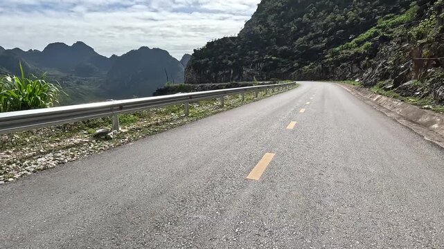 POV motorbike ride on the Ha Giang Loop, Northern Vietnam. Winding roads, misty mountains, and remote villages create an immersive adventure for motorbike and travel lovers.