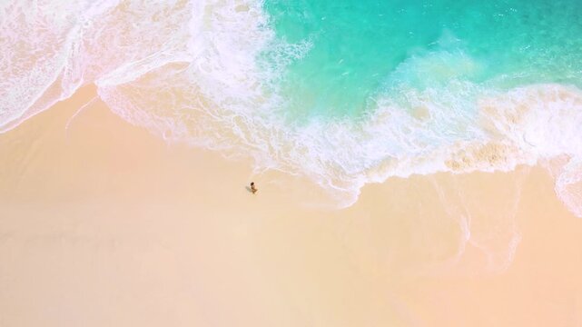 Aerial Slow Motion Over Woman At Turquoise Kelingking Beach Shoreline