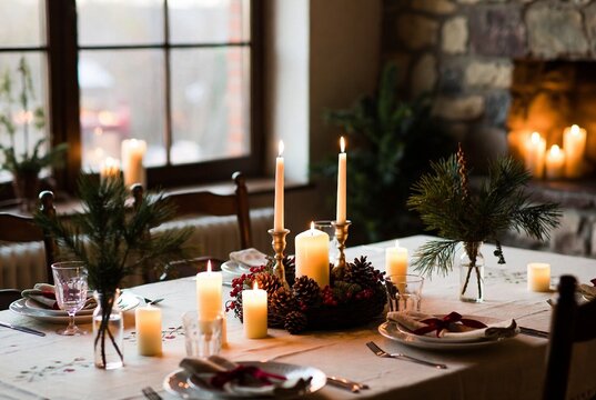 elegant candlelit dining table with festive decor and cozy stone fireplace
