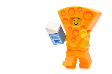 Naklejka premium Editorial illustrative image of lego minifigure of yellow cheese isolated on white.