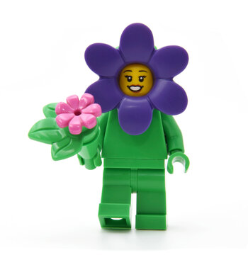 Editorial illustrative image of lego minifigure of violet flower  isolated on white.