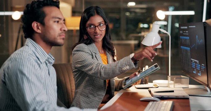 Investing, technology or people in office at night, market stats review or advice for investment. Coaching, trading team or late data analysis with computer screen, pointing or tablet for stock chart