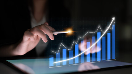 Person using stylus on tablet to analyze financial growth chart, showcasing data visualization and business strategy for success in technology-driven market. Impute