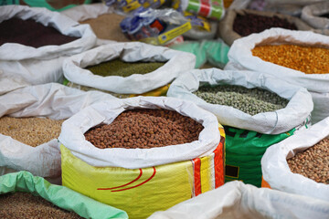 bags of black channa,grains and pulses displayed in an open market