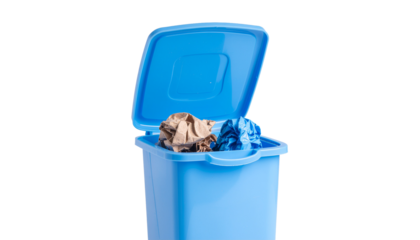 Blue plastic trash can with an open lid containing crumpled paper and other waste material, centered in the frame. solid white background