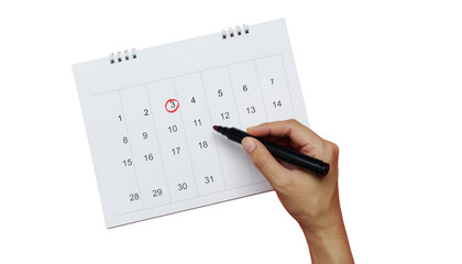 A hand marks date circled in red on calendar isolated on white bg cutout