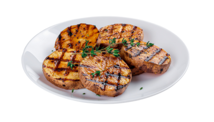 Grilled potato slices with grill marks and green herbs on a white plate, arranged in a circular pattern. isolated on a neutral background