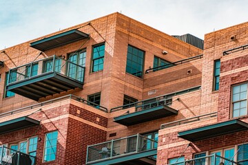 Modern urban residential building with brick facade and balconies showcasing contemporary city living and architectural design