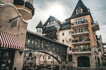 Historic architectural scene featuring traditional European buildings with timber framing and a covered bridge in a charming old town setting
