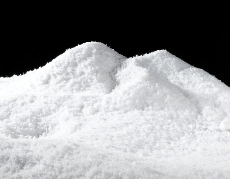 Pristine white snow piles against a stark black background, creating a striking contrast and minimalist winter scene.