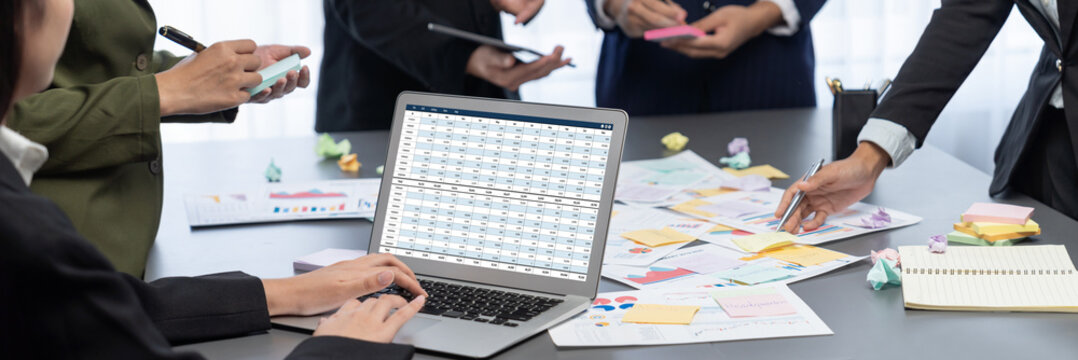 Analyst team use sticky note for creative and analytic brainstorm for business idea with BI data dashboard on laptop screen. Analysis financial data visualization tech for marketing strategy. Prodigy