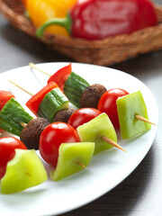 a mixed vegetable souvlaki made of red and green pepper,cherry tomato,mushroom and cucumber