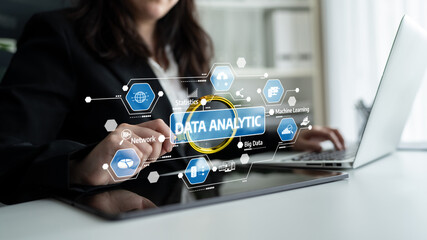 A professional woman engages with her laptop, focusing on data analytics. Digital icons and graphics represent key concepts in data science and machine learning in a modern office setting. Tessel
