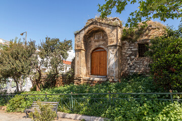 Athens, Greece. The surviving gate of the Old Madrasa (Medrese), originally built as an Ottoman theological school in 1721, now framed by vegetation in a small Aerides Plaka plaza