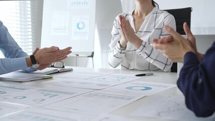 Business people team clapping hands in meeting celebrating success with financial charts, data analysis, and teamwork achievement in modern office - Powered by Adobe