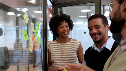 Diverse business team brainstorming ideas with sticky notes - Powered by Adobe