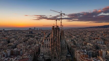 Aerial view of the Sagrada Familia cathedral in Barcelona during a beautiful sunset, showcasing the intricate architecture.