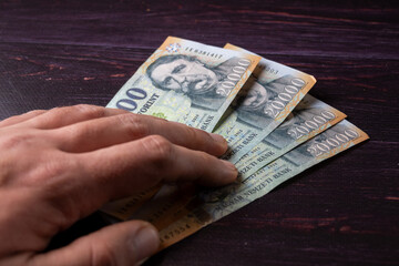 Open hand partially coverin 20.000 ft banknotes