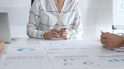 Team collaboration in modern office with financial documents, charts and graphs on desk, professionals discussing strategy, planning, and analysis during meeting. Diverse business people group at work - Powered by Adobe