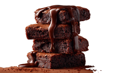 Rich, moist chocolate brownies piled high, topped with decadent dark chocolate sauce