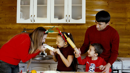 A family is enjoying time together baking in the kitchen for Christmas