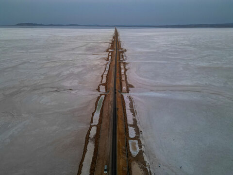 Drone shot of the surreal &ldquo;Road to Heaven&rdquo; stretching across the vast salt desert of Kutch, India.